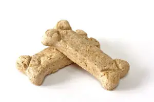 two dog biscuits laying on top of each other on a white background