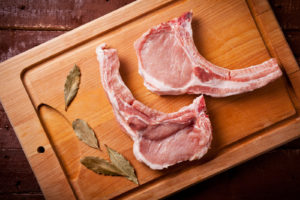 Close up of two pork chops with bay leaves - can shih tzus eat pork
