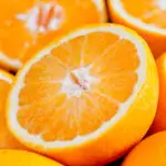 Close up photograph of a bunch of oranges