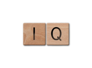 Wooden letters spelling iq on white background