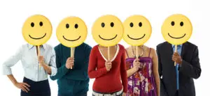 multiethnic group of people holding smiley emoticons on white background