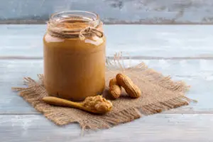 Creamy peanut butter on wooden table