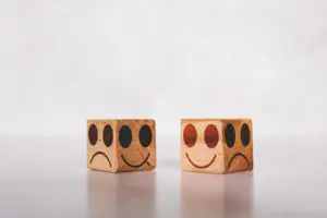 wooden block with frowny faces