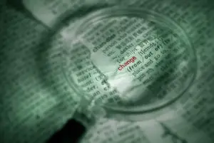 Find word of change in papers with magnifier in green color.