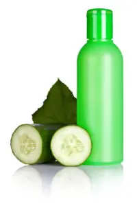 Lotion with fresh cucumber slice and leaf on white background