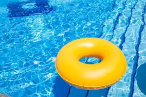 inflatable yellow inner tube floating in clear blue waters